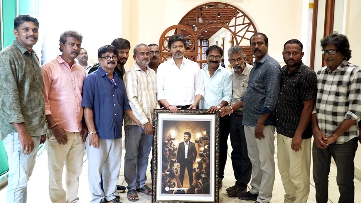 Tamil Nadu CM Vijay poses with portrait gifted by photographers