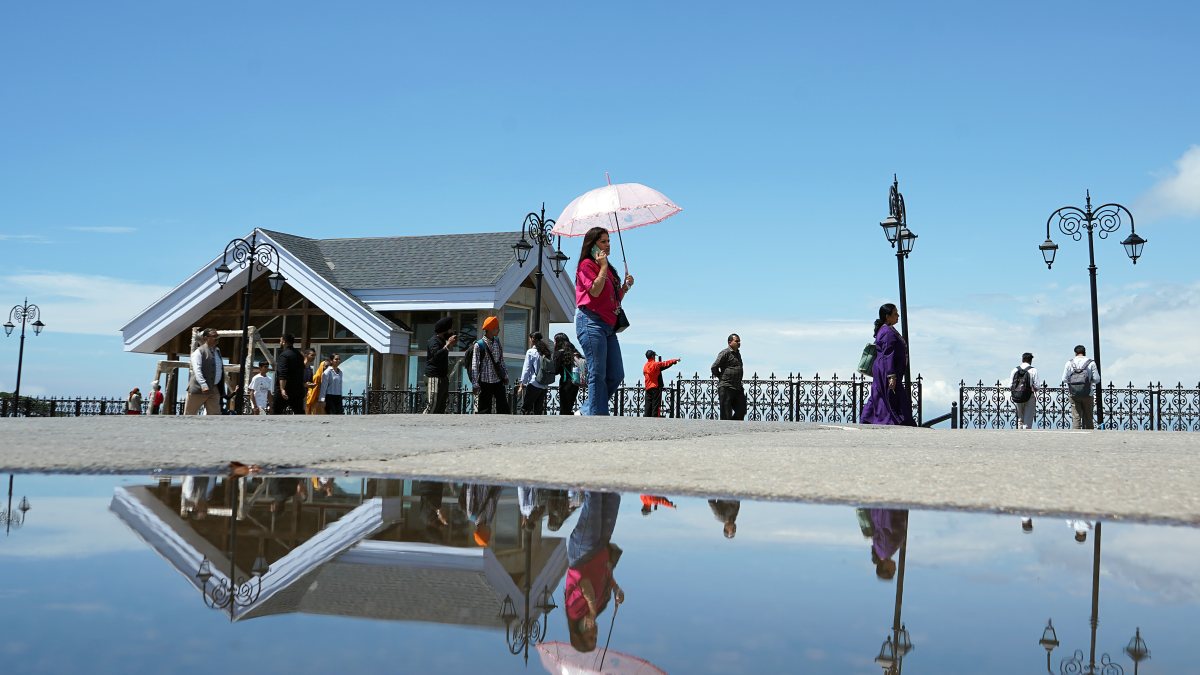 Tourists soak up sunshine after light rain in Shimla