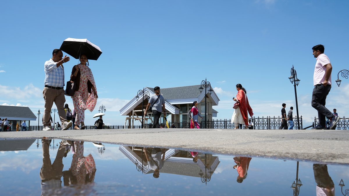 Tourists soak up sunshine after light rain in Shimla