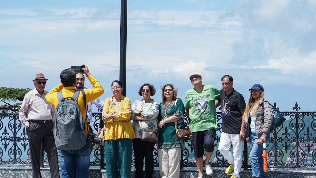 Tourists pose for group photo in Shimla after light rain