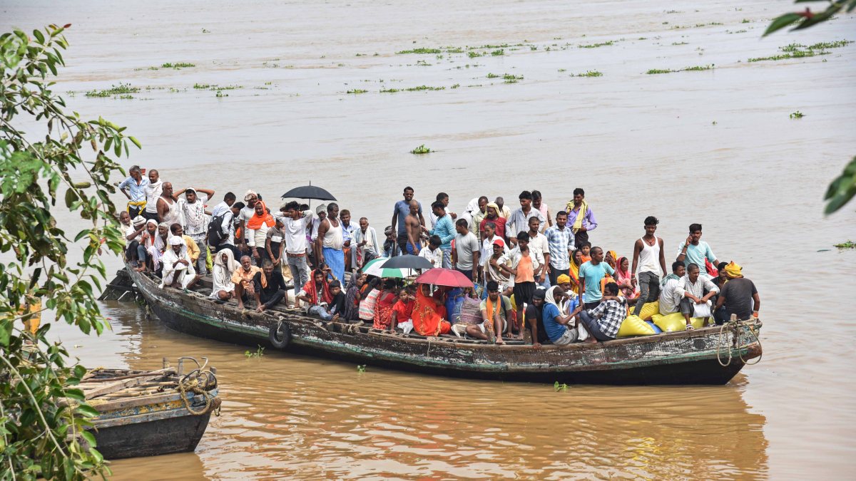 Boat carries people from flood-hit Nakta Diyara in Patna