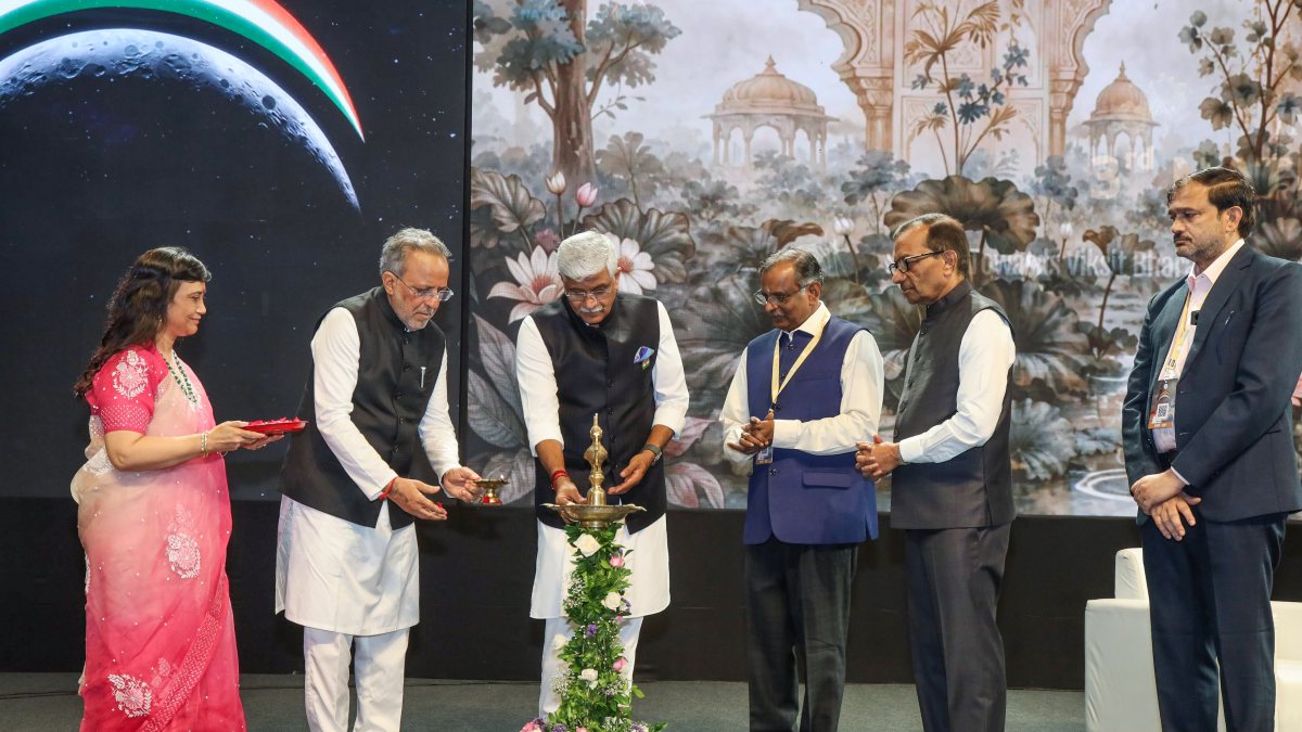 Minister lights lamp at ISRO National Space Day event in Ahmedabad