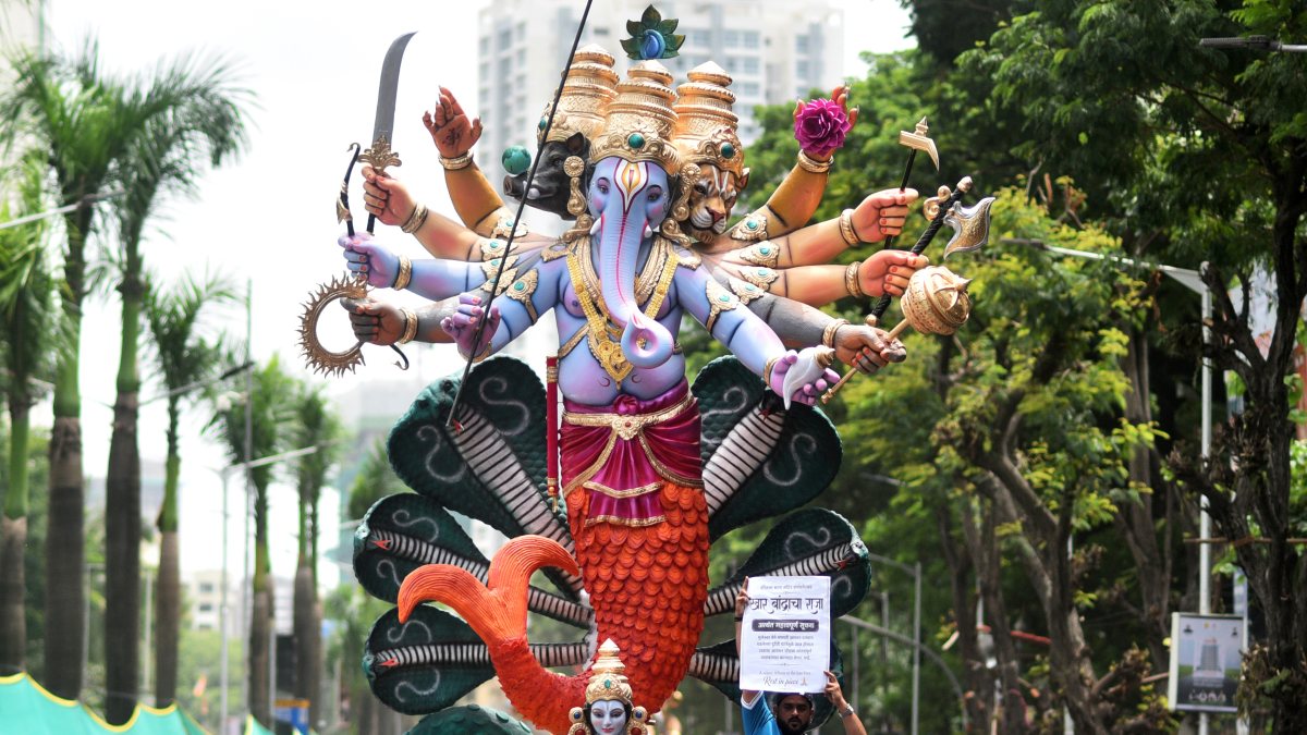 Mumbai devotees carry Ganesh idol to pandal amid festivities