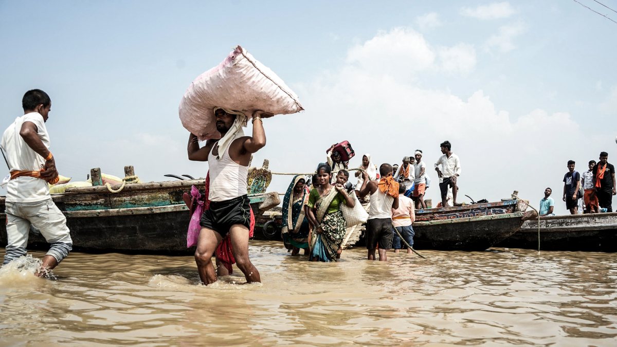 Flood-hit Patna residents wade through Ganga waters to safety