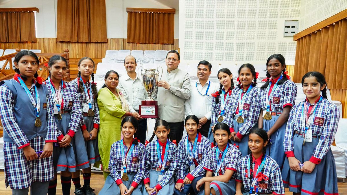 Uttarakhand CM Dhami poses with students in Dehradun
