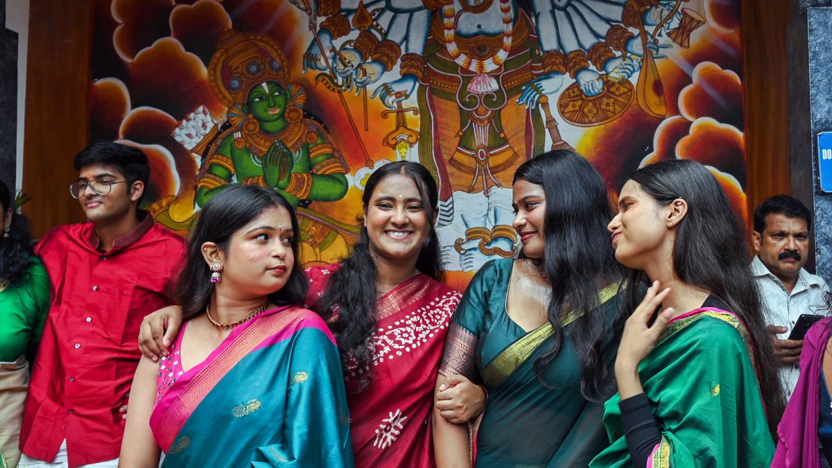 People pose for photos at Delhi temple during Onam festivities