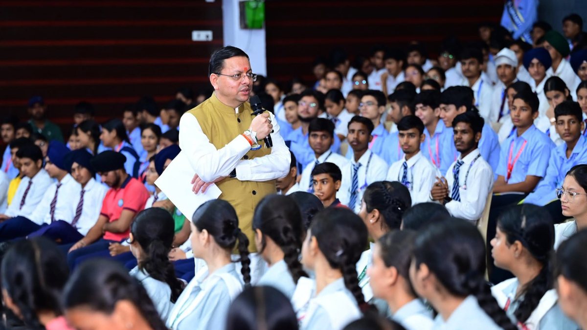 Dhami interacts with students at Yuva Vidyarthi Manthan in Rudrapur