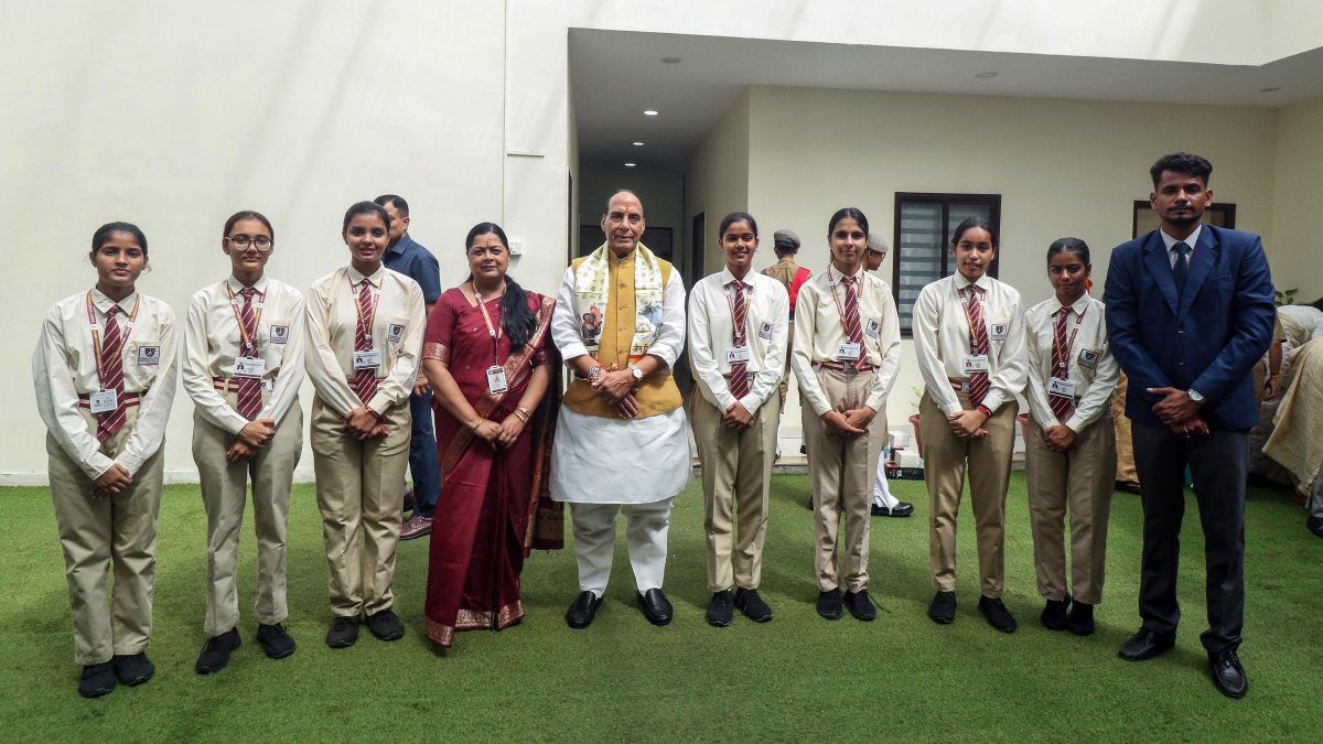 Students pose with Rajnath Singh on Raksha Bandhan