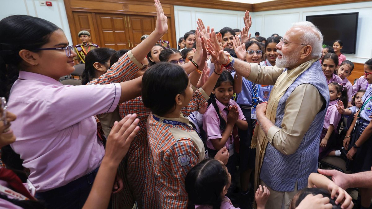 PM Modi high-fives school children at Raksha Bandhan event