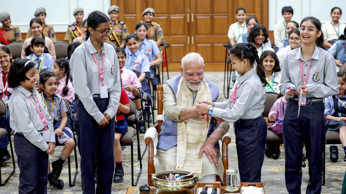 PM Modi receives Rakhi from school child at Raksha Bandhan event