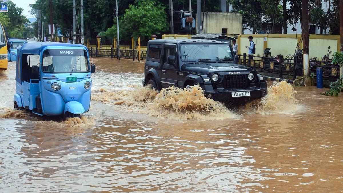 Guwahati commuters wade through waterlogged street after heavy rain