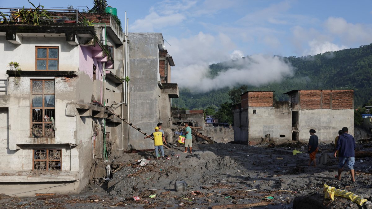 Nepal villagers clear debris after flash floods and mudslide