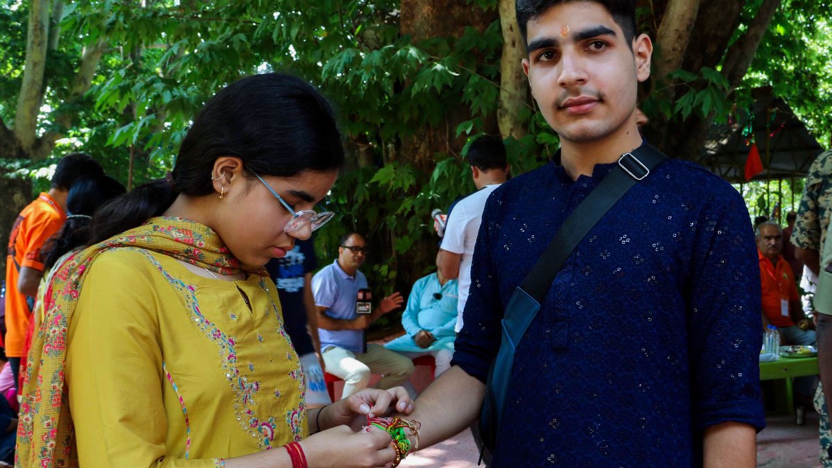 Sister ties rakhi on brother's wrist at Anantnag temple on Raksha Bandhan