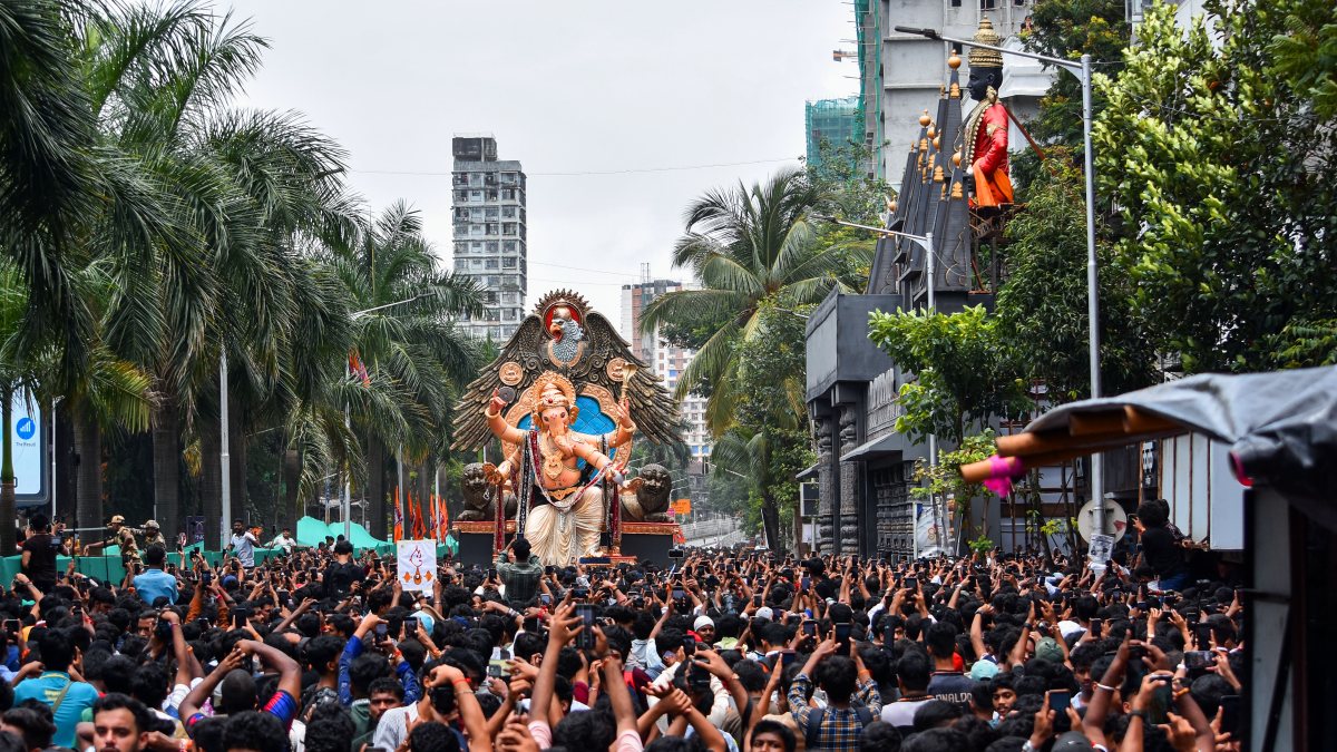 Adani Group members carry Ganesh idol to Mumbai pandal