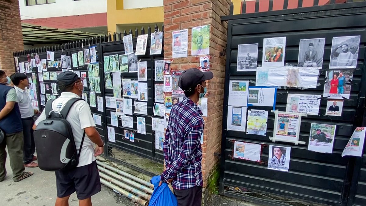 Kathmandu residents scan missing persons posters after floods