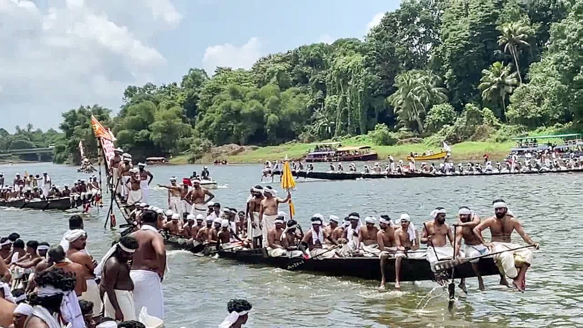 Oarsmen row snake boats at 132nd Aranmula boat race