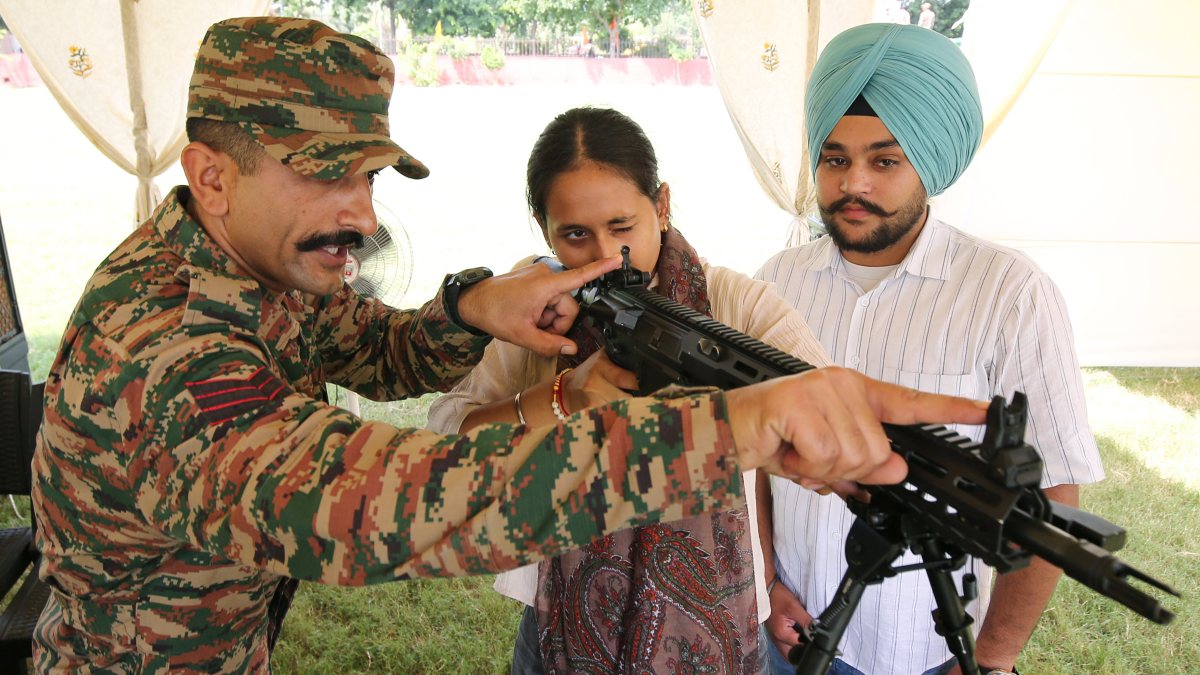 Student inspects Indian Army gun at Amritsar weapons exhibition