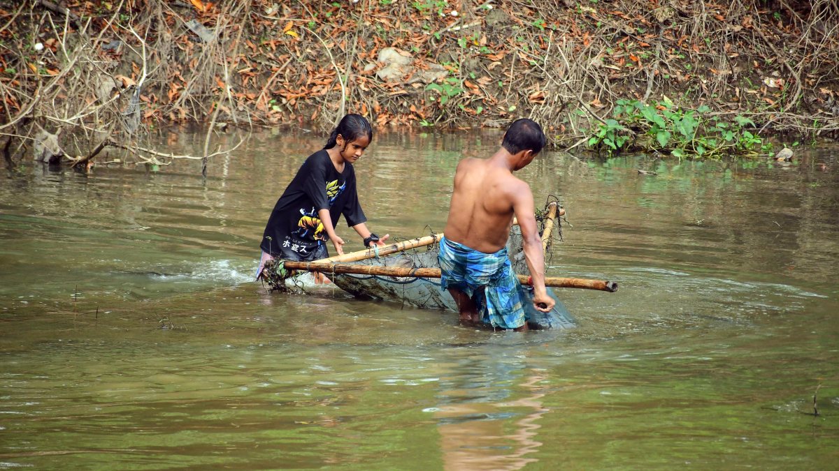 Fishing duo cast nets in Kolong River, Nagaon