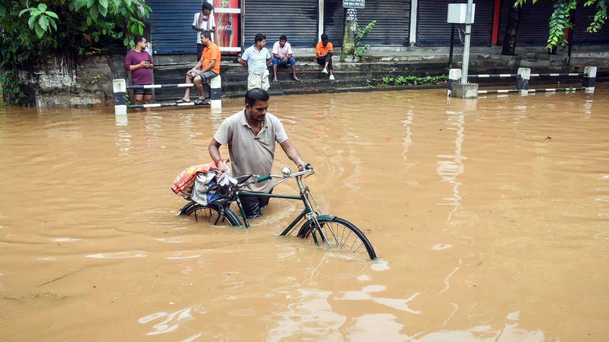 Man navigates waterlogged Guwahati road on cycle after heavy rain