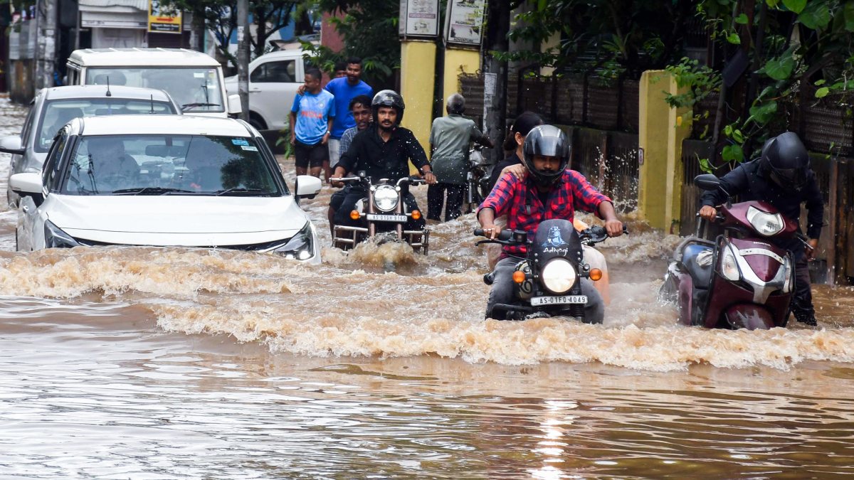 Guwahati commuters wade through waterlogged Rajgarh road after heavy rain
