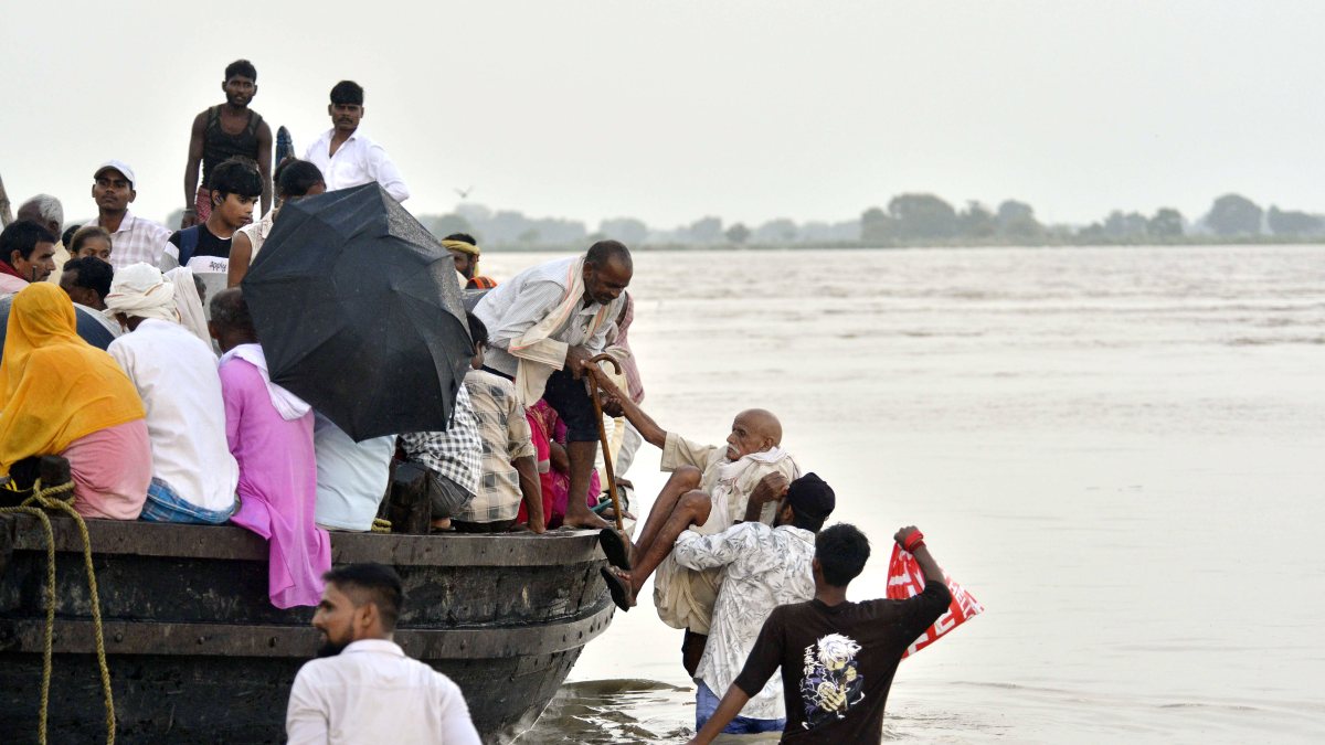 Overloaded boat crosses flooded Ganga in Patna