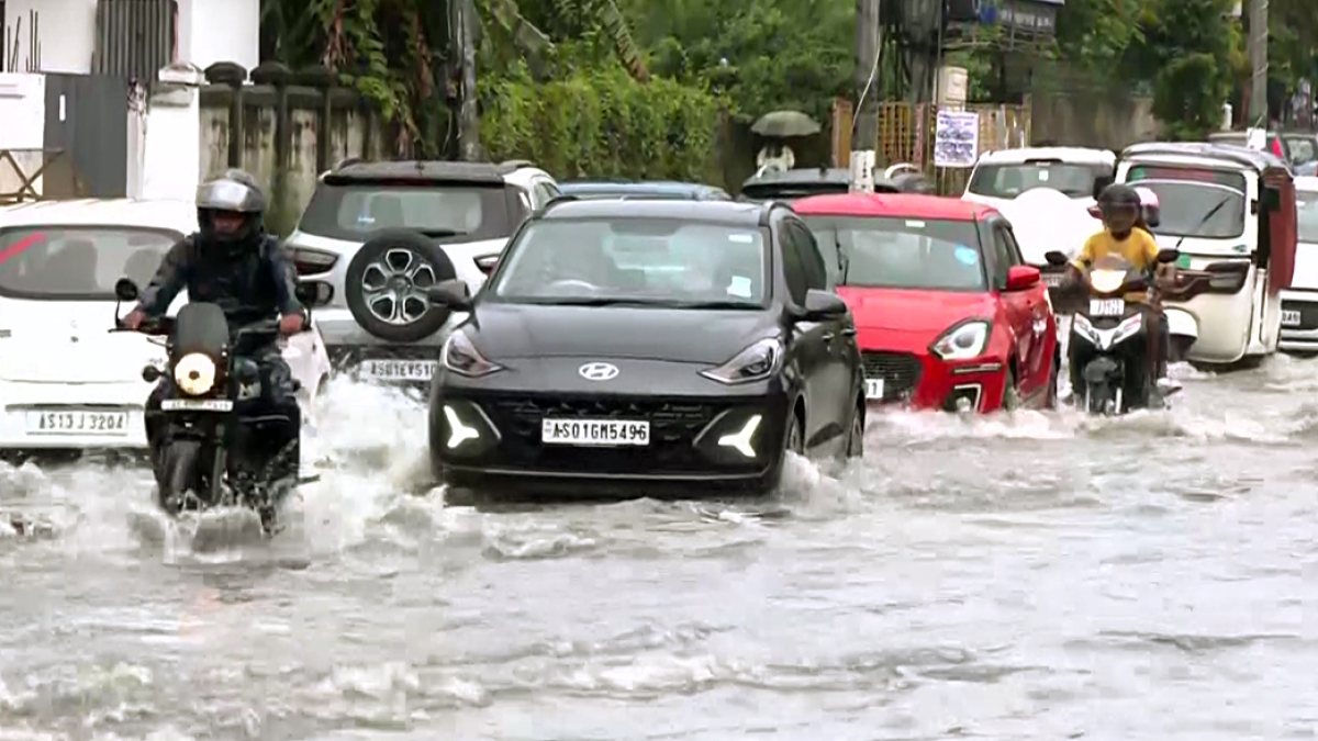 Guwahati commuters wade through waterlogged street after heavy rain