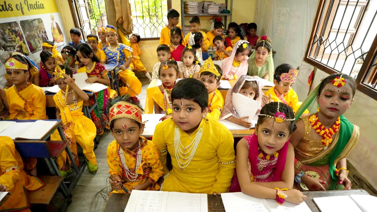 Children in Krishna-Radha costumes attend school ahead of Janmashtami