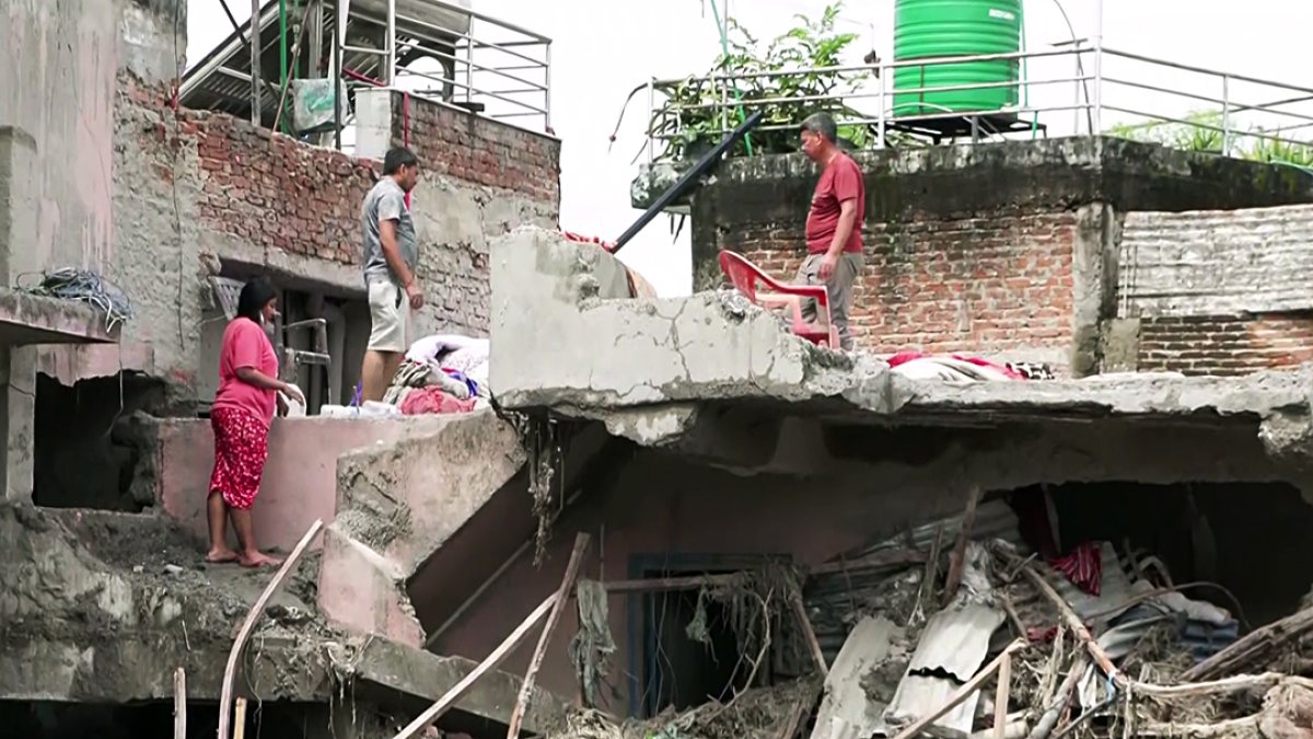 Nepal flood victims clear mud from destroyed homes