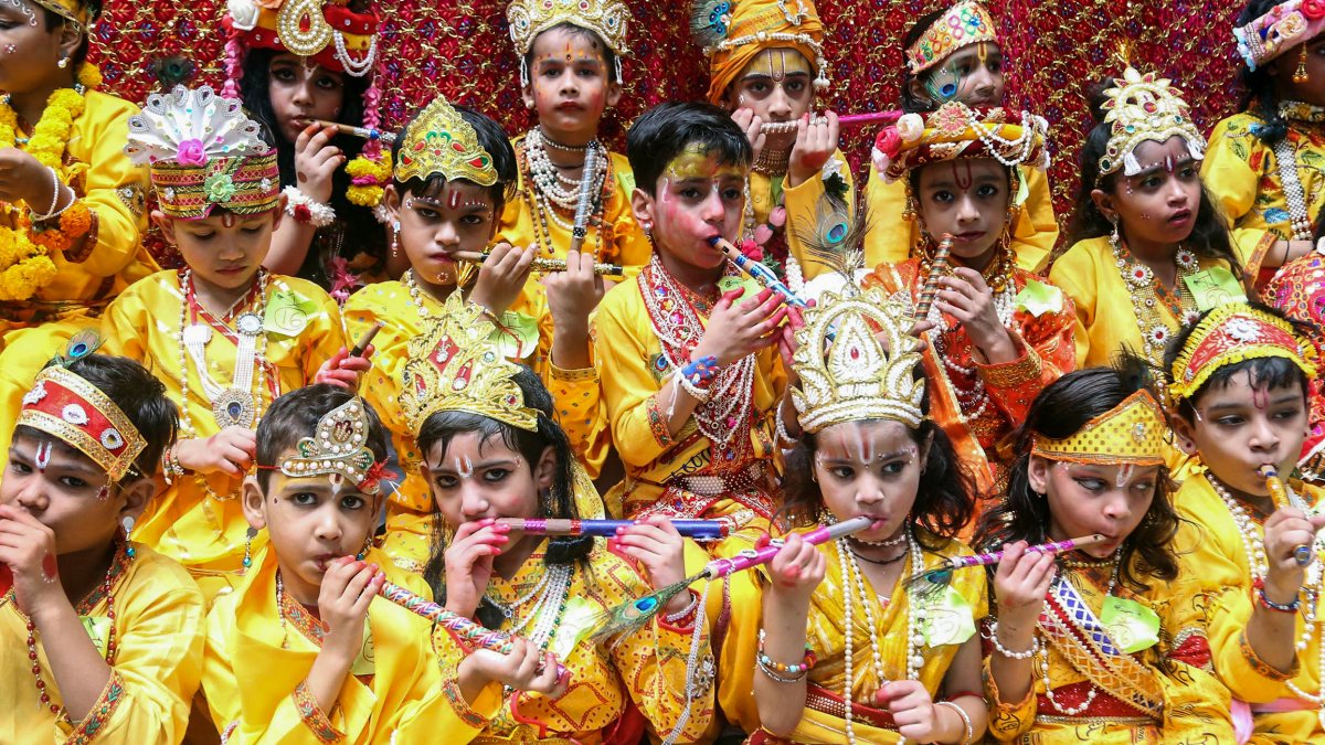 Kids in Krishna costumes pose at Janmashtami event