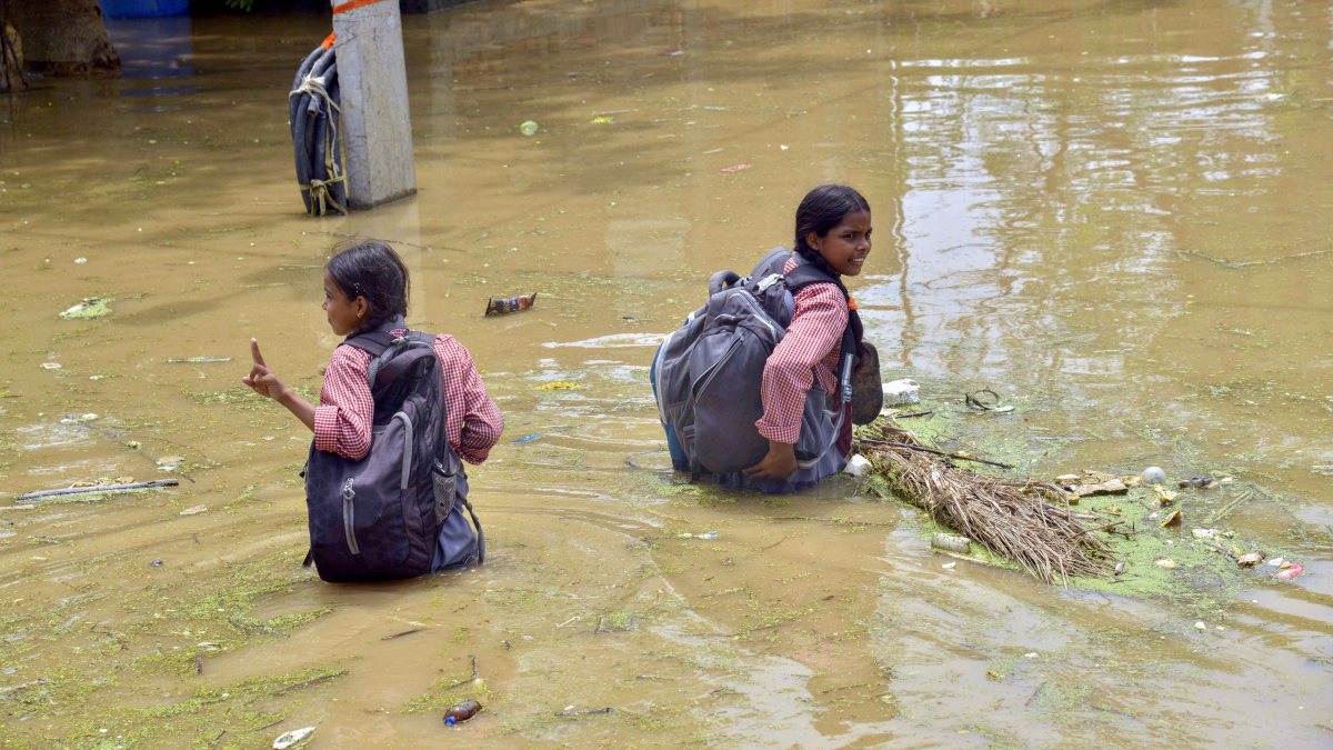 Patna school students wade through floodwater after Ganga rises