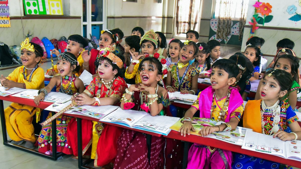 Students in Krishna-Radha costumes attend class before Janmashtami