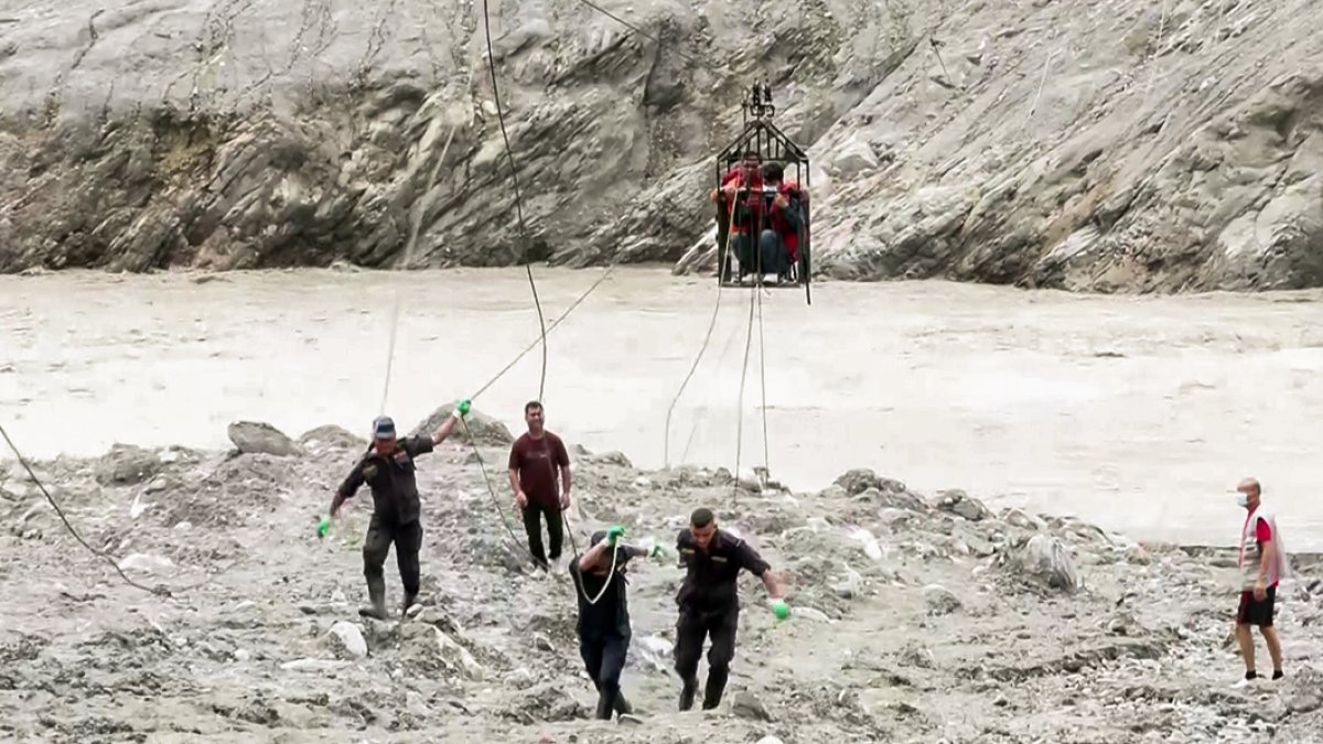 Nepal villagers cross river on makeshift zip line after floods
