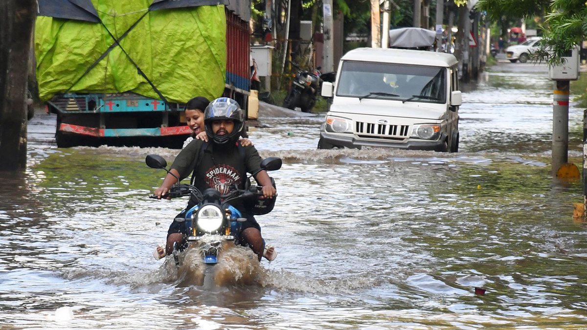 Guwahati commuters wade through waterlogged Anil Nagar road