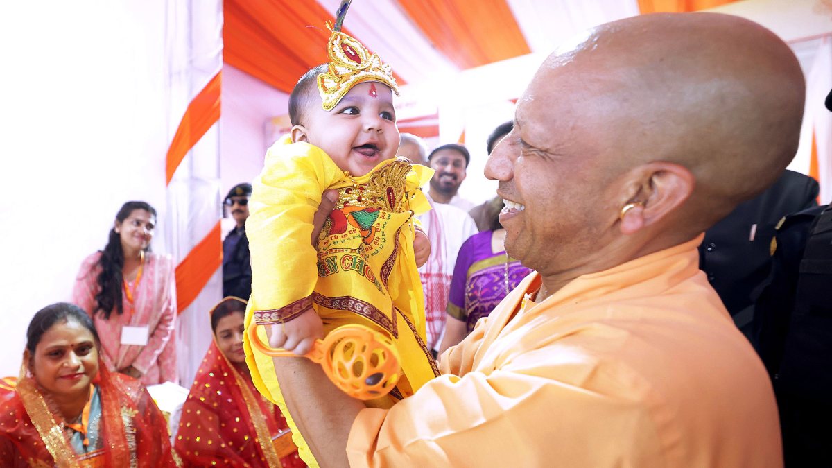 Yogi Adityanath holds child Krishna on Janmashtami in Mathura