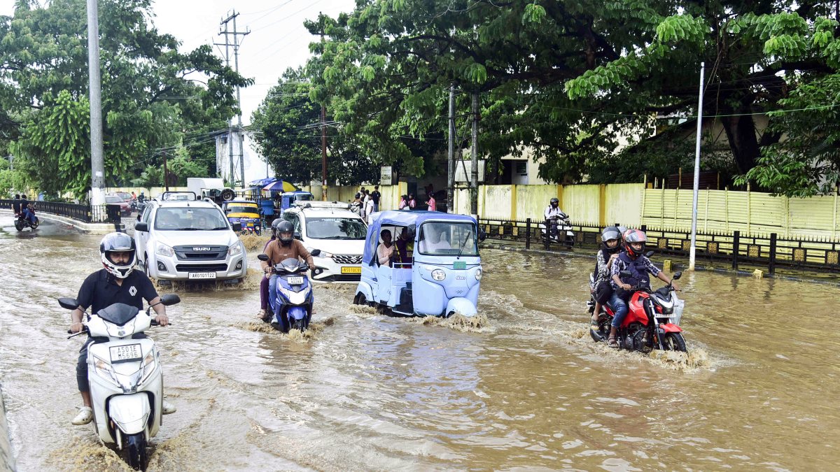 Guwahati commuters wade through waterlogged road after heavy rain