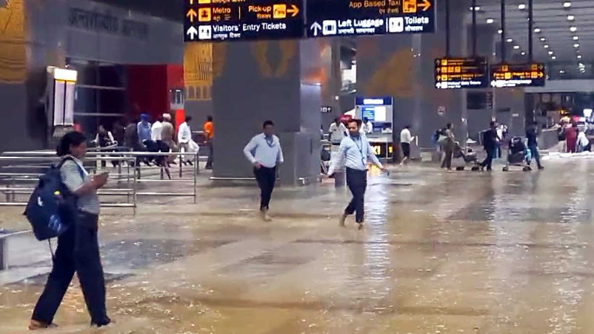 Delhi airport staff inspect waterlogging after heavy rain