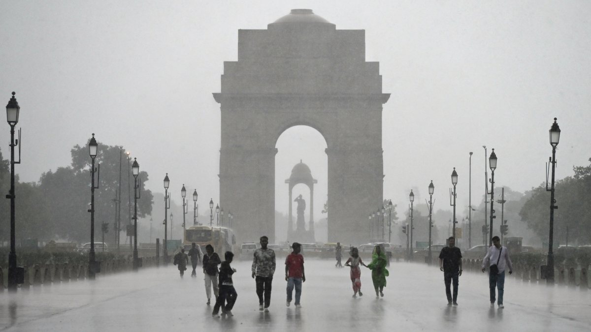Delhi residents and kids enjoy monsoon showers near India Gate
