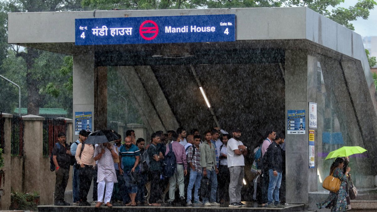 Heavy rain strands commuters at Mandi House Metro exit