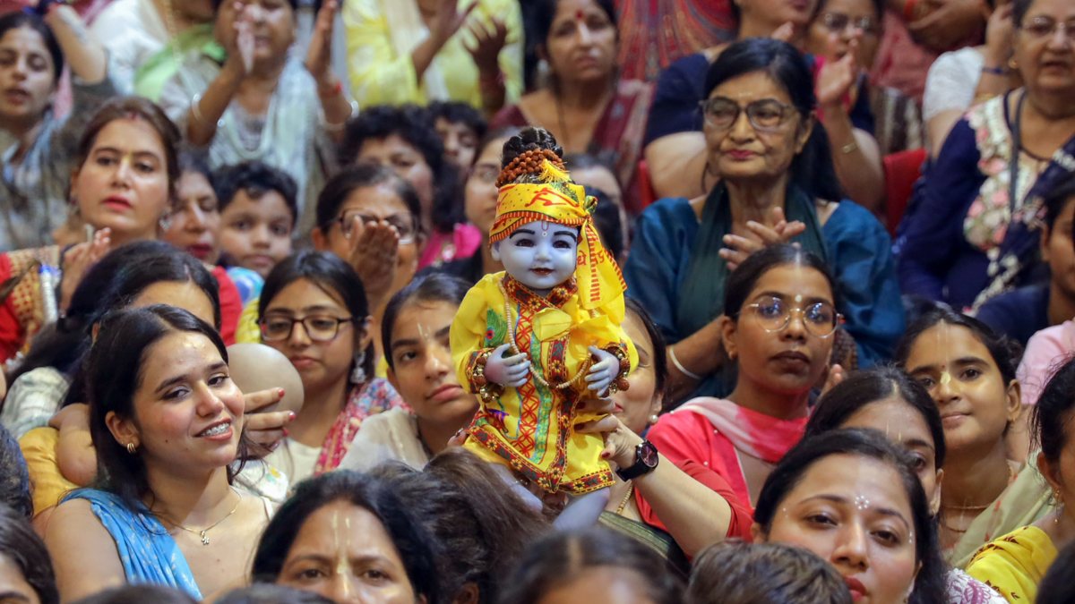 Devotee carries Lord Krishna idol during Janmashtami in Jalandhar