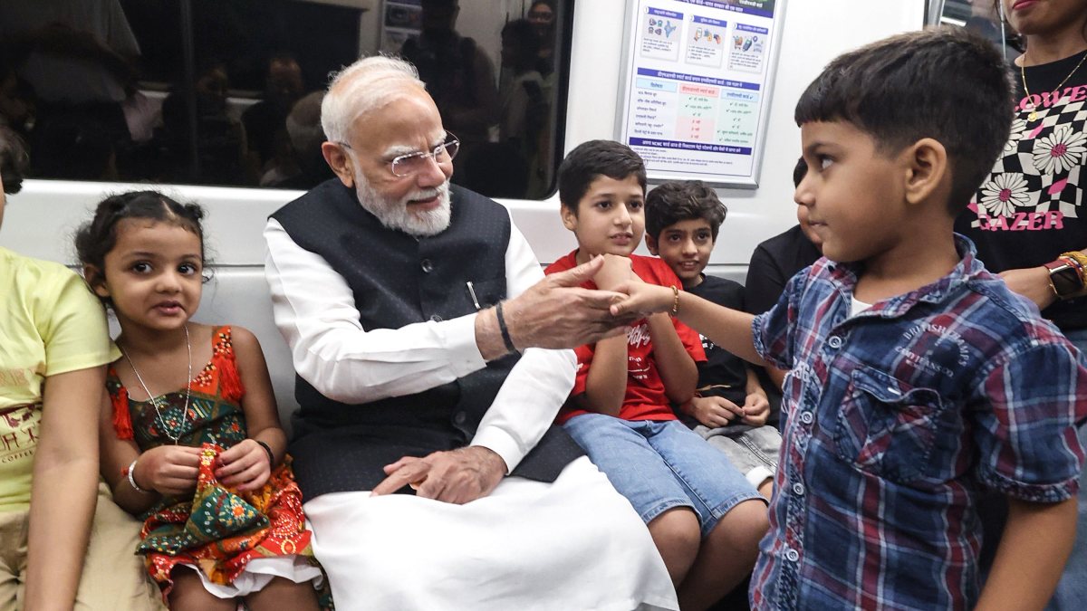 PM Modi meets child during Delhi Metro ride to SRCC event