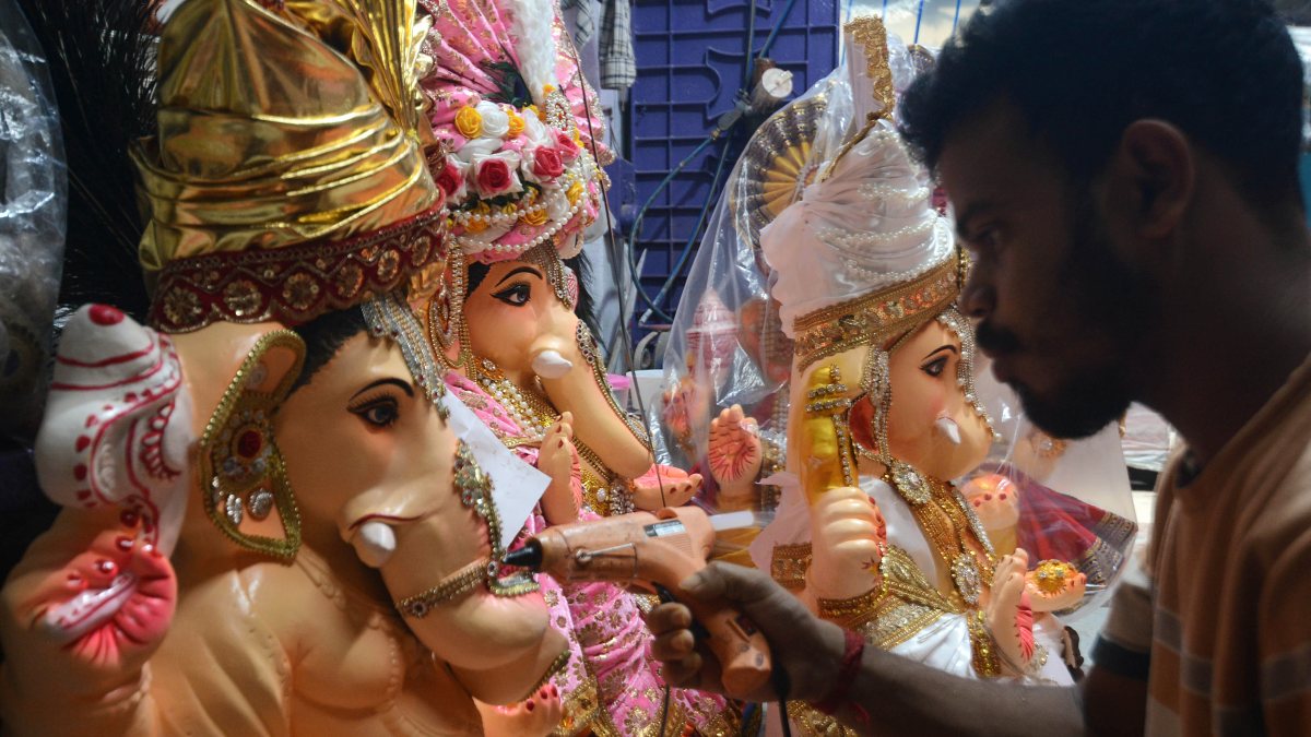 Artisan adds final touches to Ganesha idols in Kolkata