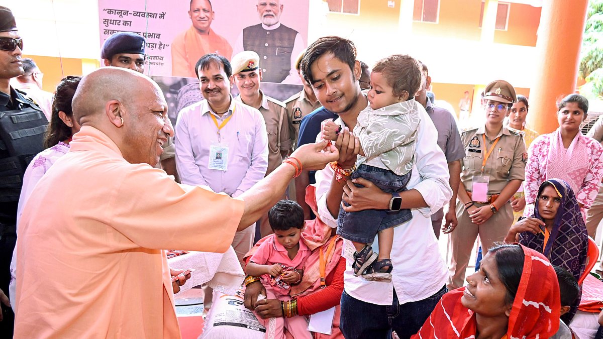 Yogi Adityanath interacts with child during Chitrakoot flood inspection