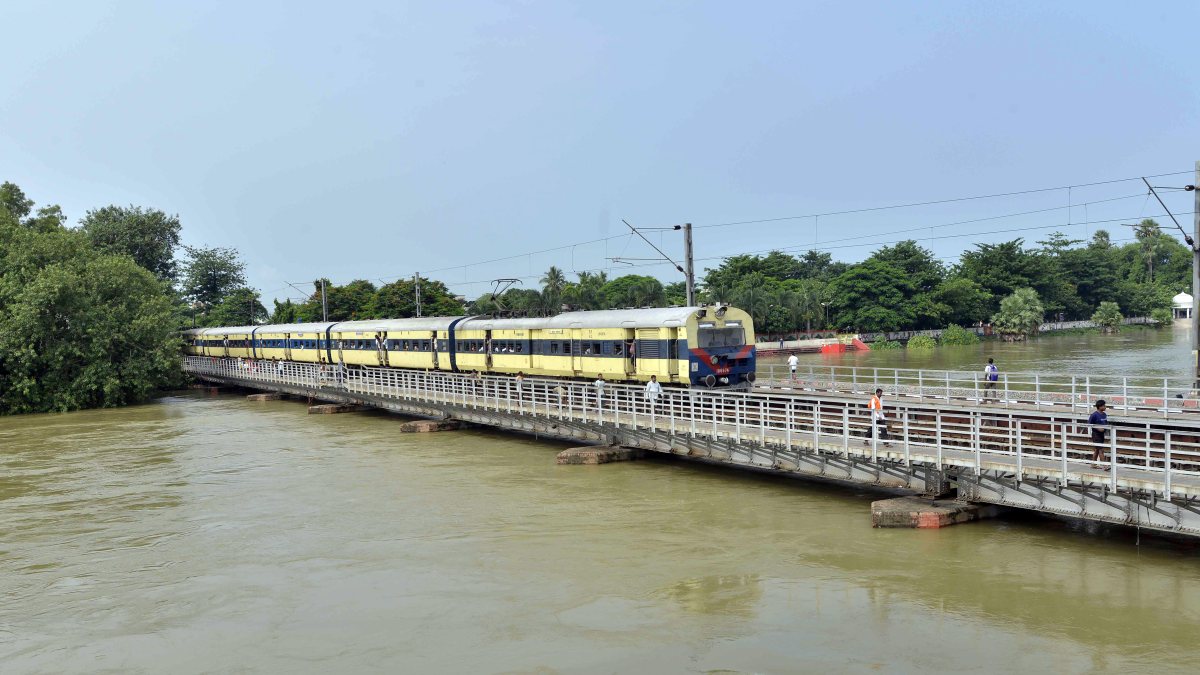 Passenger train crosses flooded bridge in Patna