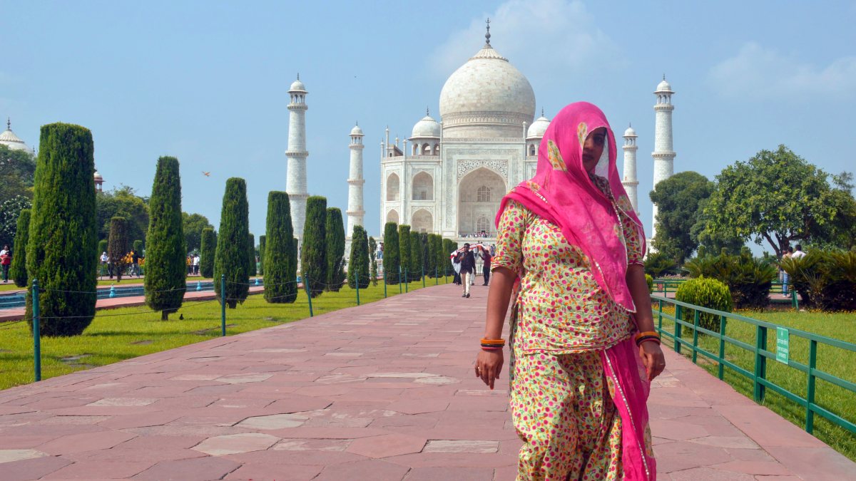 Heatwave grips Agra as woman shields from sun near Taj Mahal