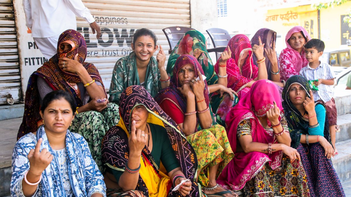 Women show ink-marked fingers after voting in Jaipur municipal polls