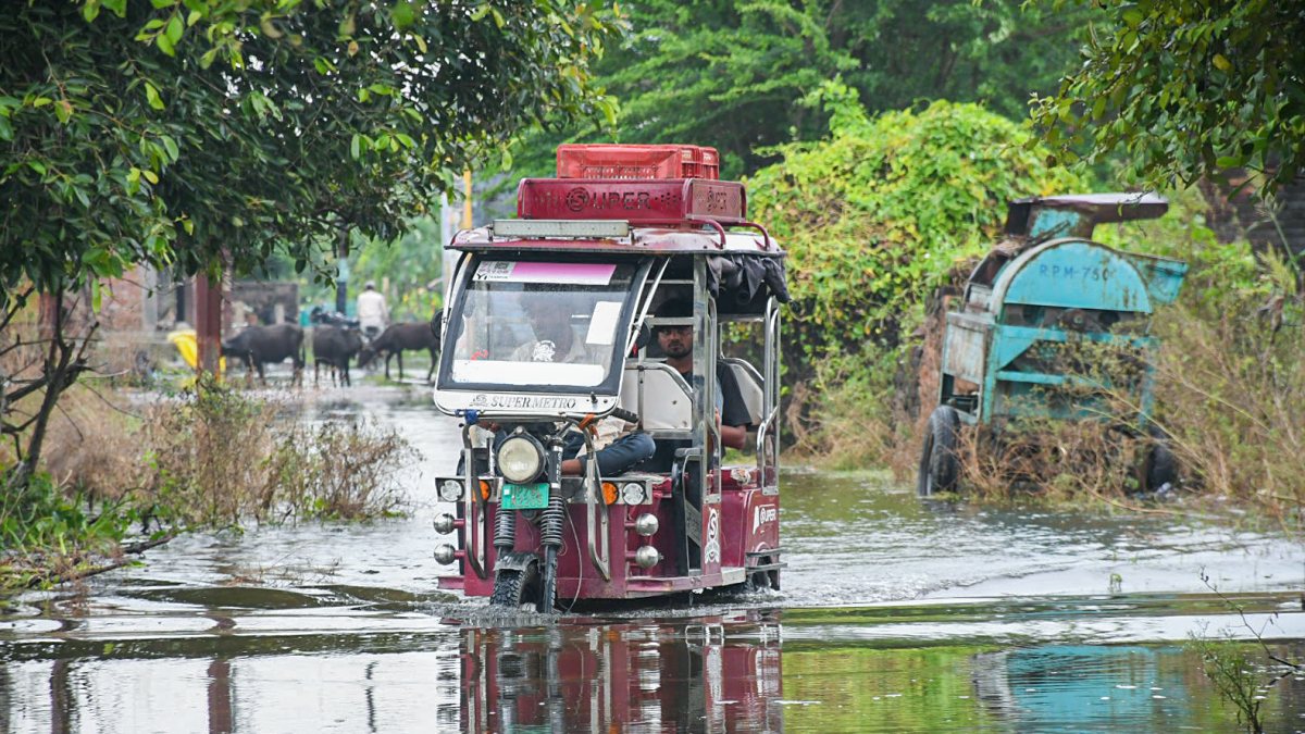E-rickshaw wades through floodwaters in Kanpur