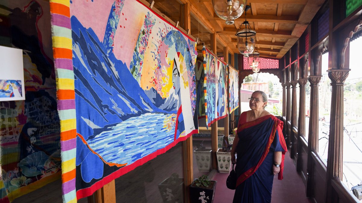 Visitor admires hand-painted Pashmina shawl at Srinagar exhibition