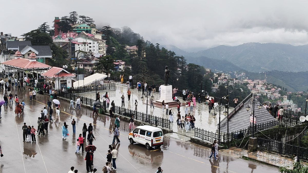 Shimla residents walk with umbrellas amid intermittent rain