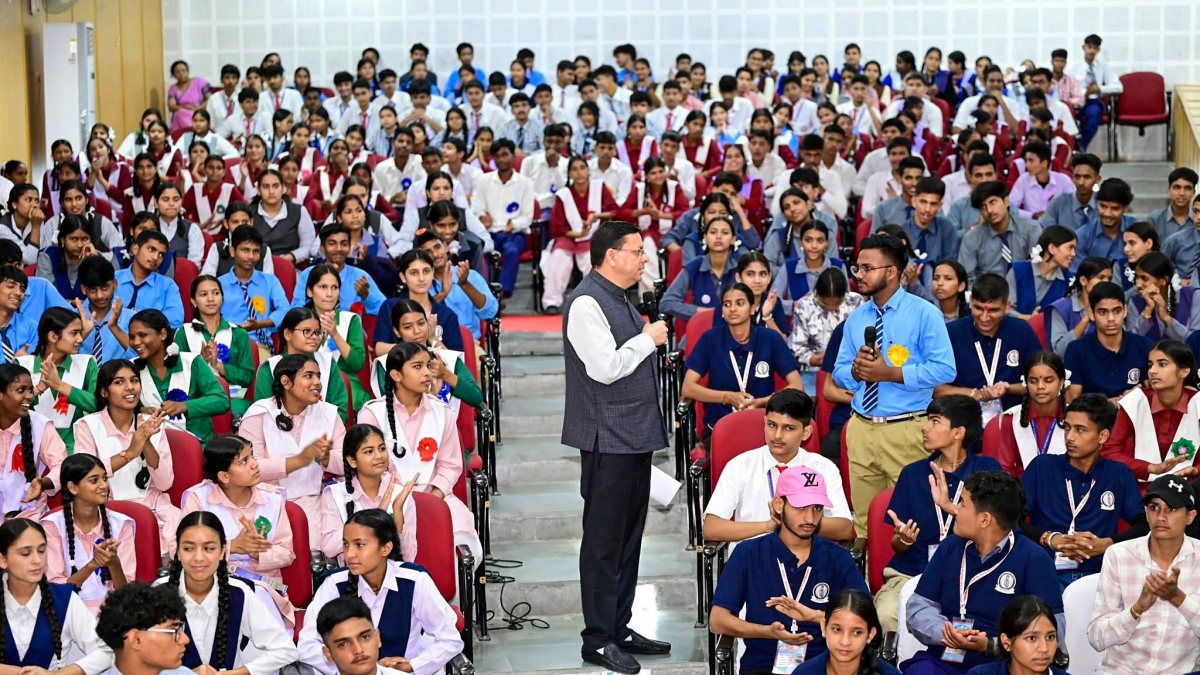 Dhami interacts with student at Yuva Vidyarthi Manthan in Tehri Garhwal