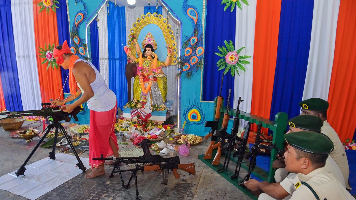 Priest performs Vishwakarma Puja rituals as TSR jawans look on in Agartala